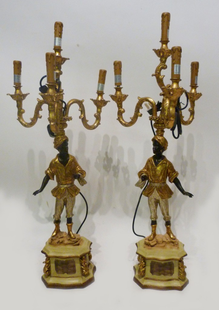 A Pair of Blackamoor Four Branch Candelabrum, each with scroll arms and with figural support