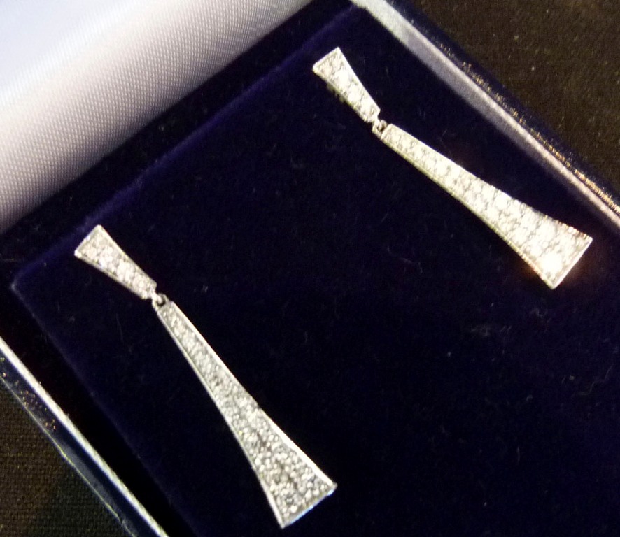 A Pair of 18ct. White Gold Diamond Drop Earrings, of tiered form, approximately 0.66ct