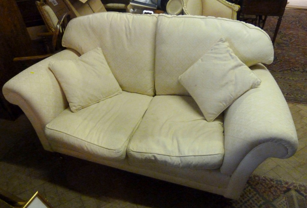 A Modern Cream Upholstered Two Seater Sofa