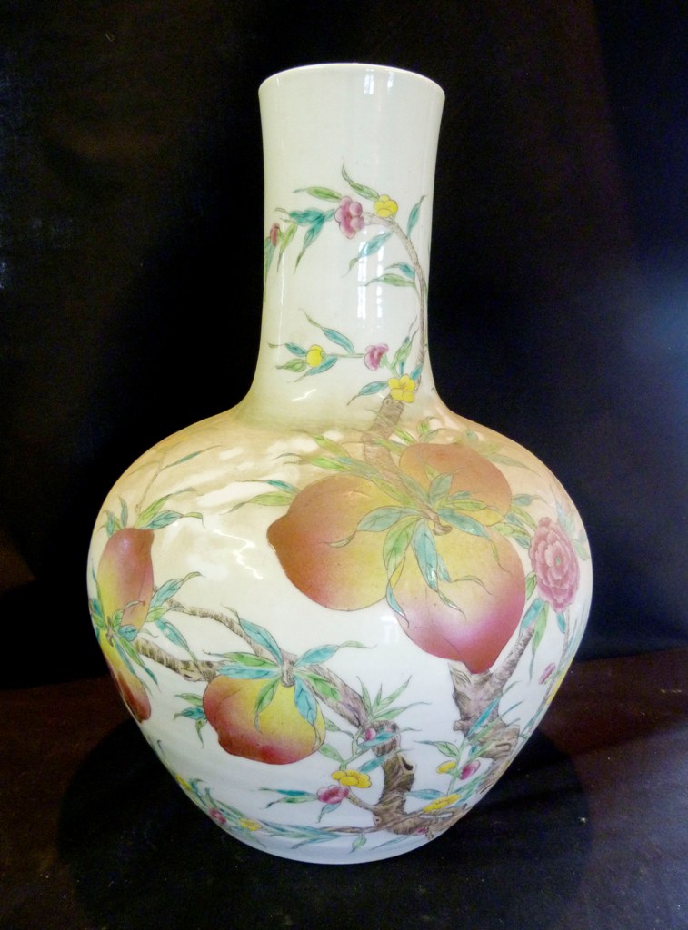 A Large Chinese Porcelain Vase, decorated in polychrome enamels with vining fruit, 54 cms tall