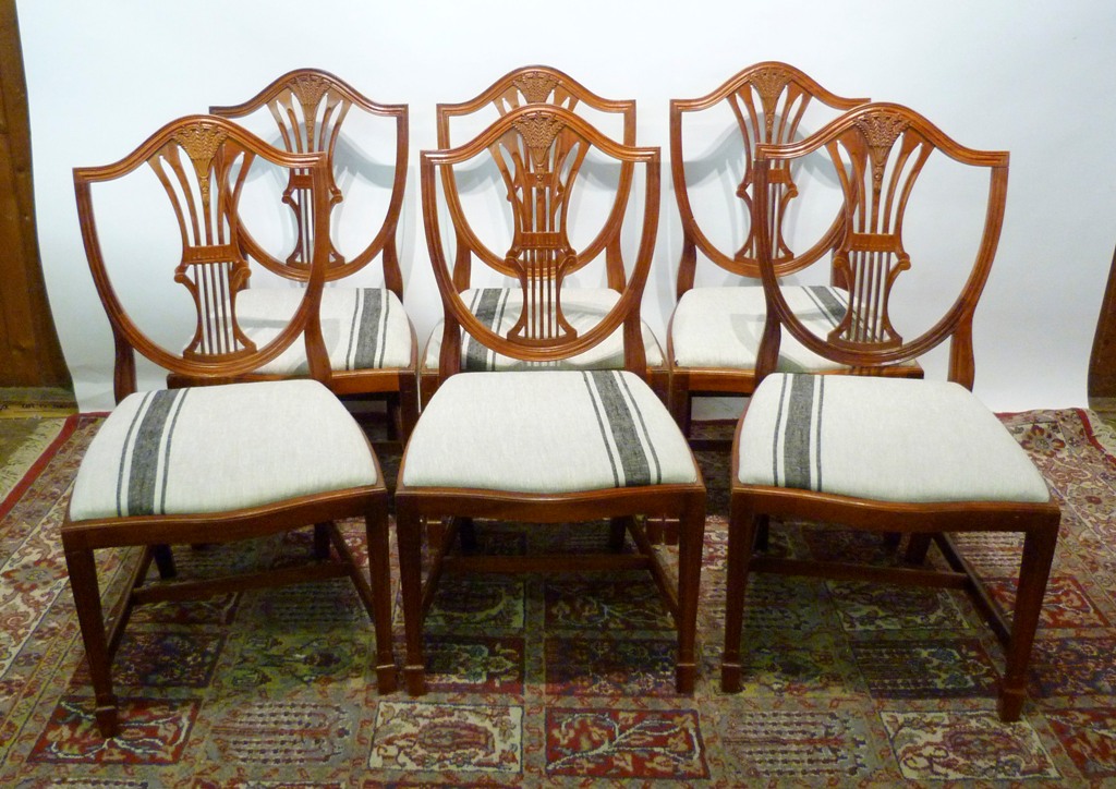 A Set of Six Shield Back Dining Chairs, with wheatsheaf pierced splat backs above drop-in seats,