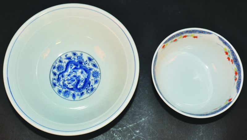 TWO ORIENTAL PORCELAIN BOWLS, one decorated with dragons, the other with garden foliage, the
