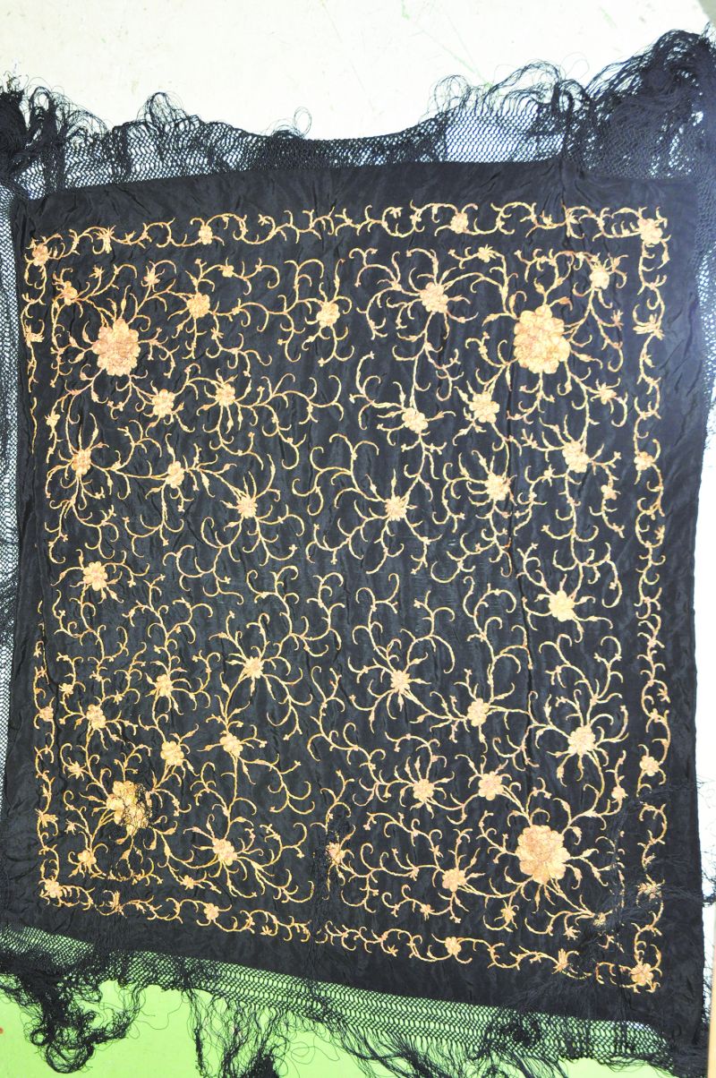 A LATE 19TH CENTURY CHINESE BLACK-GROUND SILK SHAWL, embroidered overall in gilt thread with