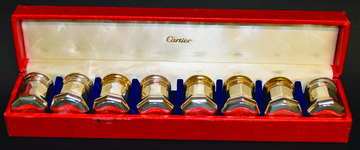 A SET OF EIGHT CARTIER STERLING SILVER CAPSTAN SHAPED PEPPERETTES in a red Cartier box.