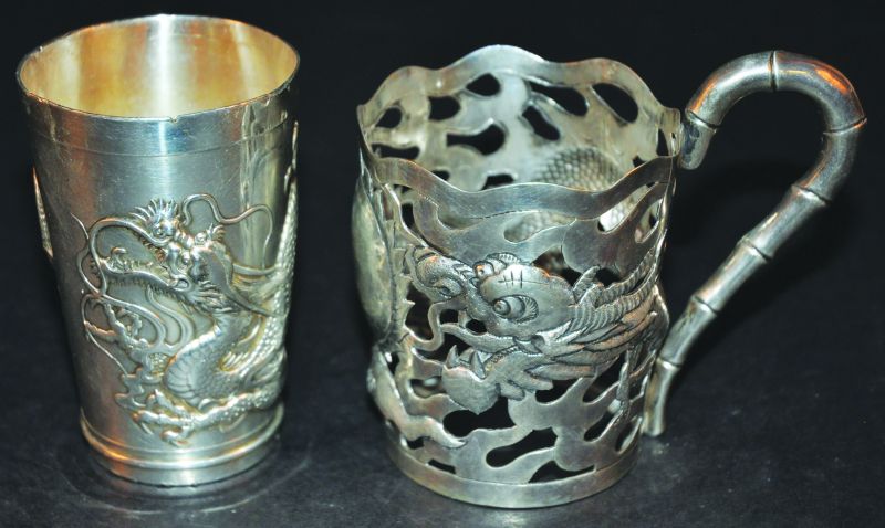 AN EARLY 20TH CENTURY CHINESE SILVER-METAL CUP HOLDER, with pierced decoration of a dragon and