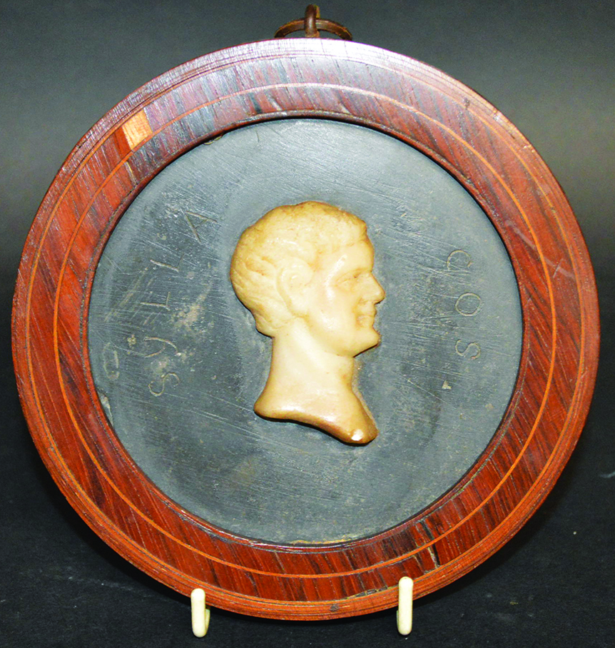 A GRAND TOUR CIRCULAR SLATE AND MARBLE PLAQUE ?SYLLA COS? with a carved marble bust in a wooden