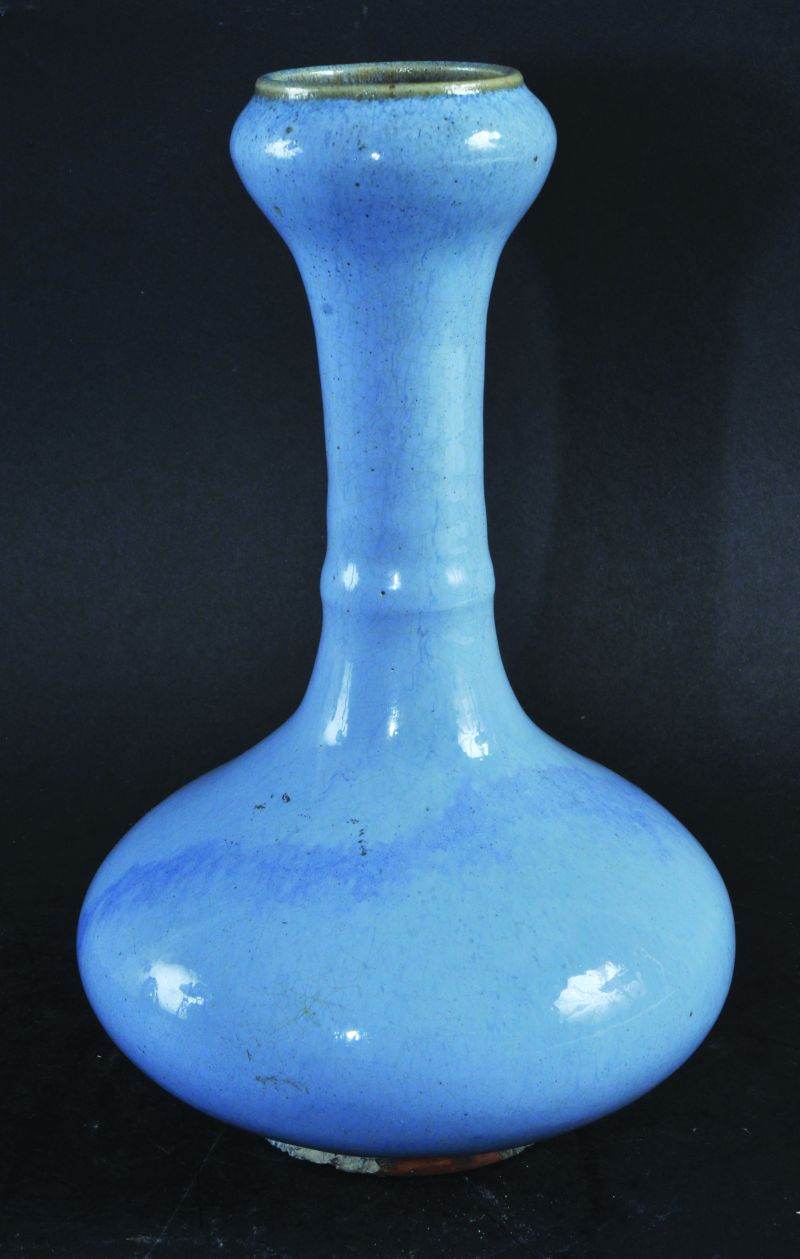 A CHINESE FLAMBE GLAZED BOTTLE VASE, unusually applied with a pale blue streaked glaze, the base