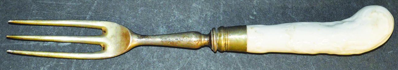 AN 18TH CENTURY BOW FORK handle moulded in white with three pronged steel fork 7ins long.