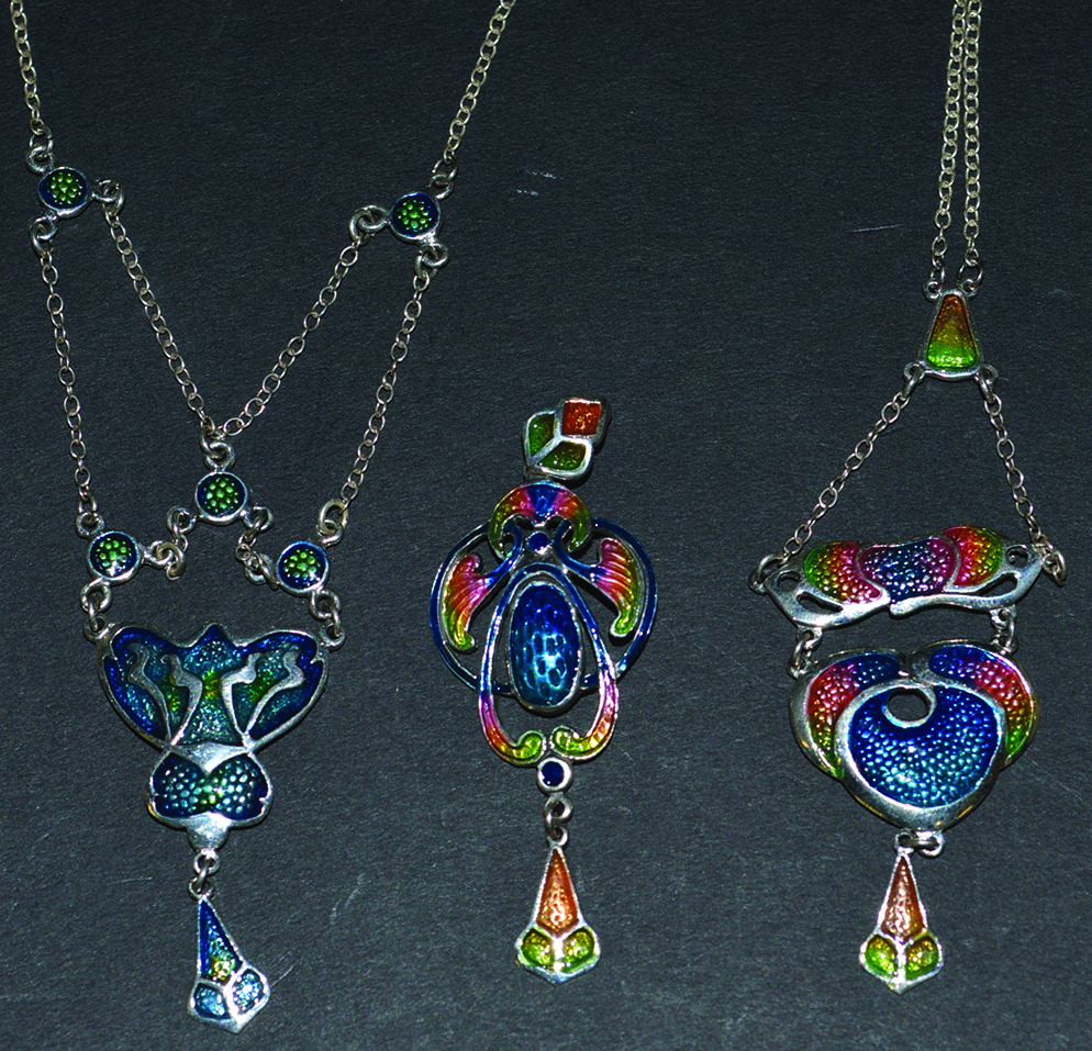 THREE ART NOUVEAU SILVER AND ENAMEL PENDANTS and two chains.