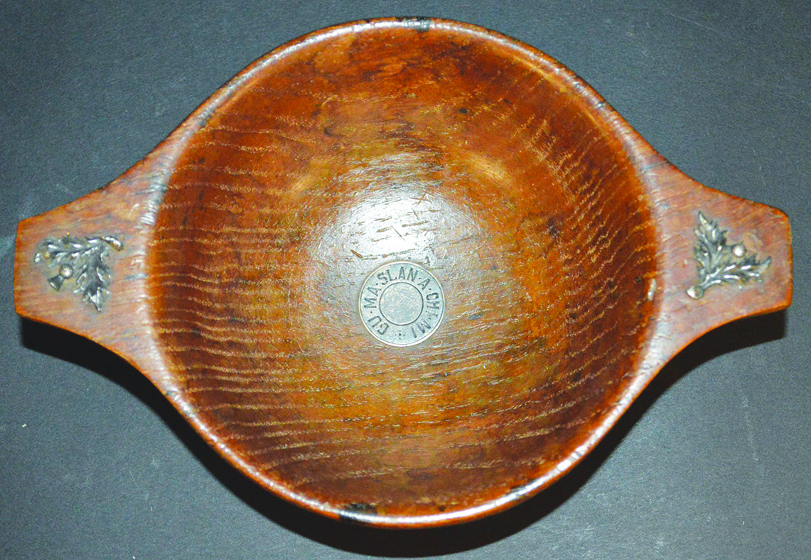 AN EARLY 19TH CENTURY QUAICH, probably ELM, with applied white metal thistles, and inscription on