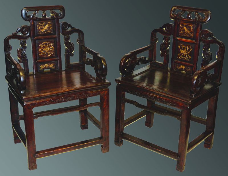 A PAIR OF CHINESE REDWOOD ARM CHAIRS, with pierced tops and three gilt panels to the back, and with