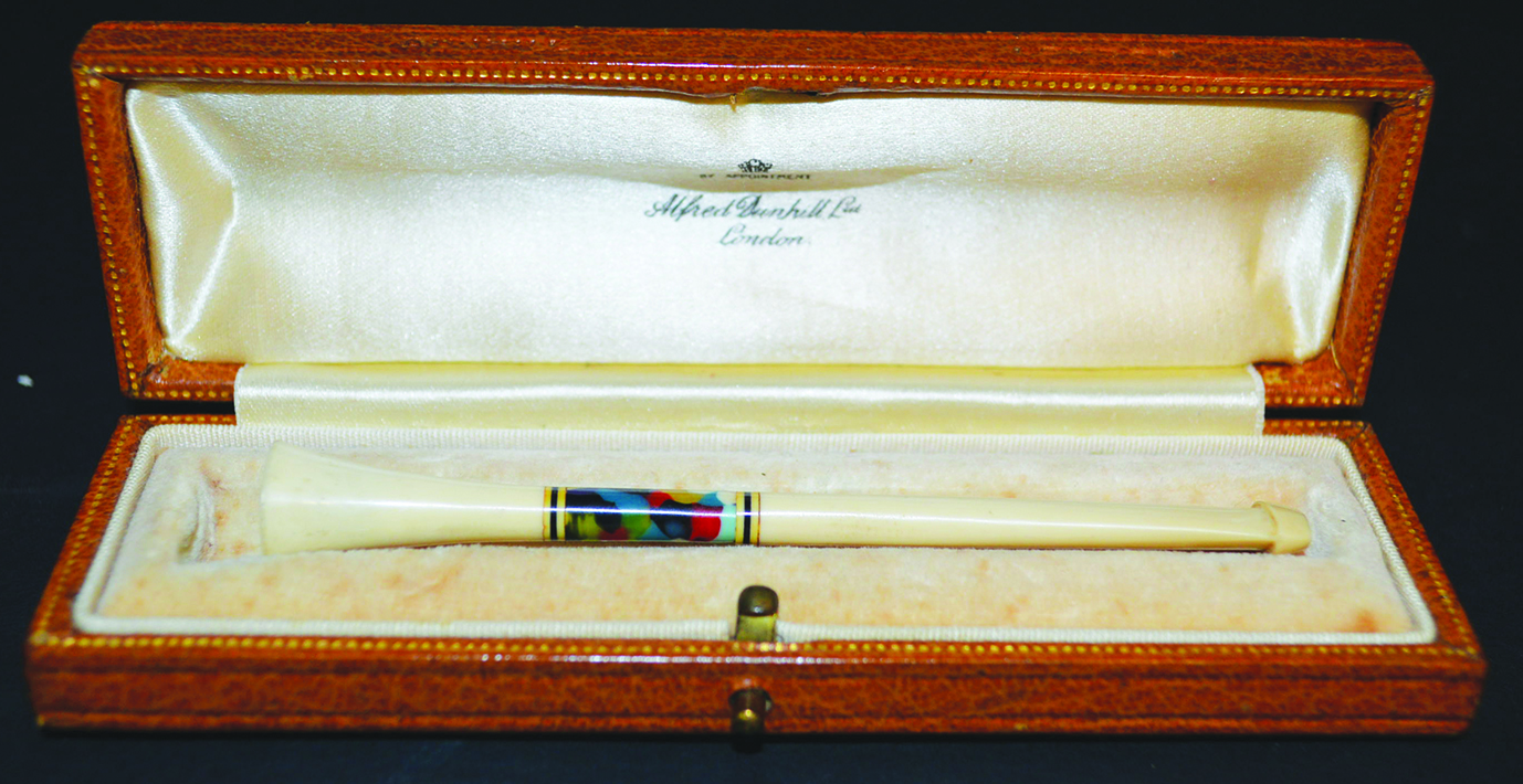 AN ASPREY DUNHILL IVORY AND ENAMEL CIGARETTE HOLDER in a leather case.