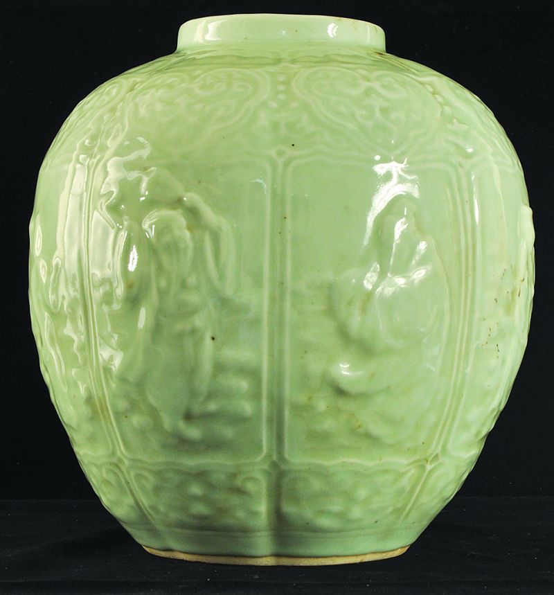 A CHINESE CELADON MOULDED PORCELAIN JAR, circa 1900, the sides moulded in relief with the Eight