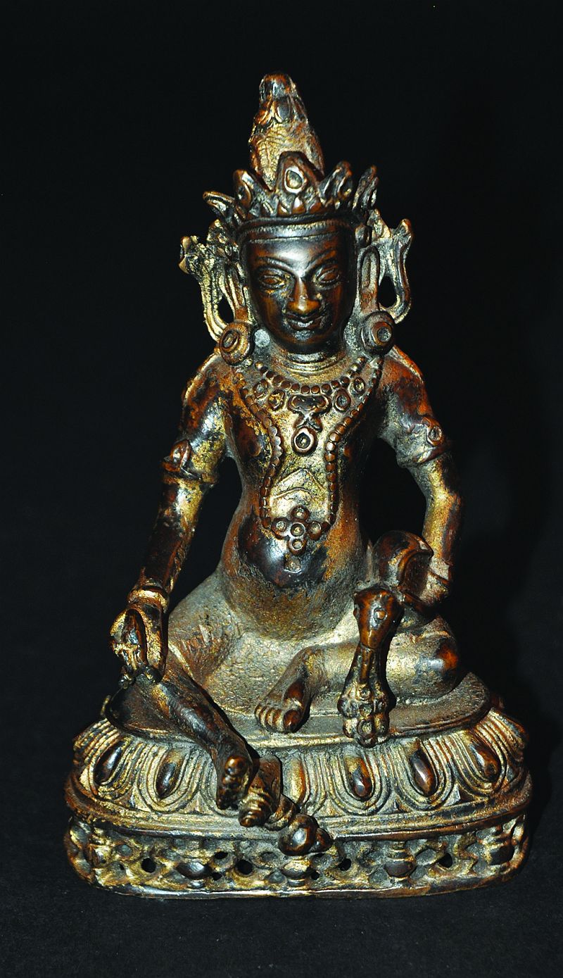 A SINO-TIBETAN GILT BRONZE FIGURE OF JAMBHALA, the God of Wealth, seated on a lotus plinth with a