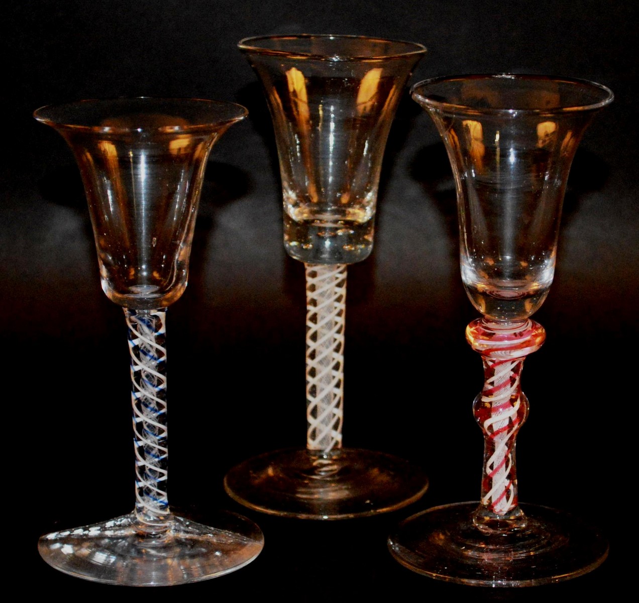 THREE WINE GLASSES with inverted bell bowls and coloured stems. 5.75ins, 6.25ins (2) high (3).