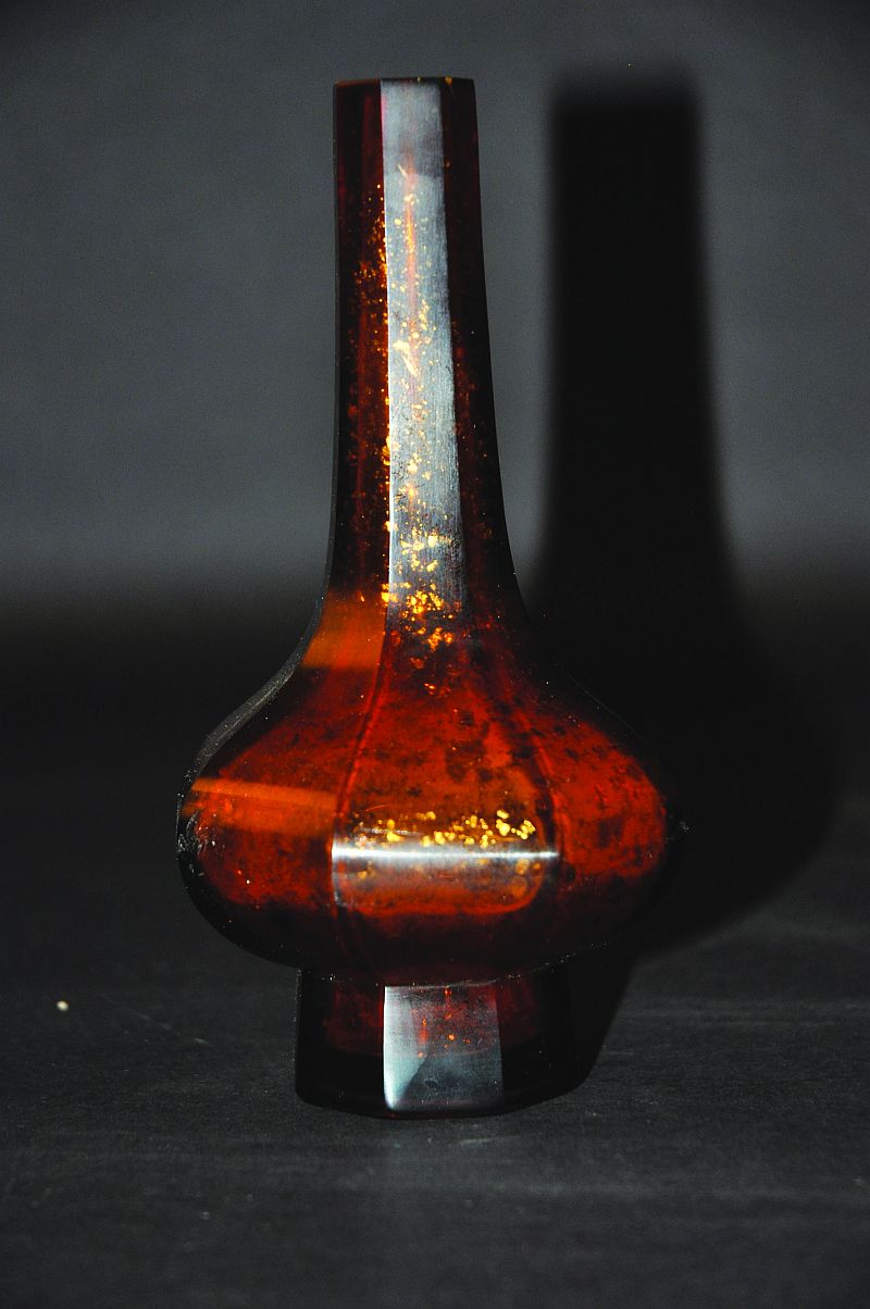 A CHINESE BEIJING AMBER GLASS VASE, of octagonal section, the pear-shaped body incorporating gilt