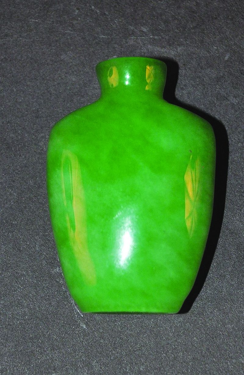 A JADE-LIKE GLASS SNUFF BOTTLE, of mottled and striated apple-green tone, 2.3in high.