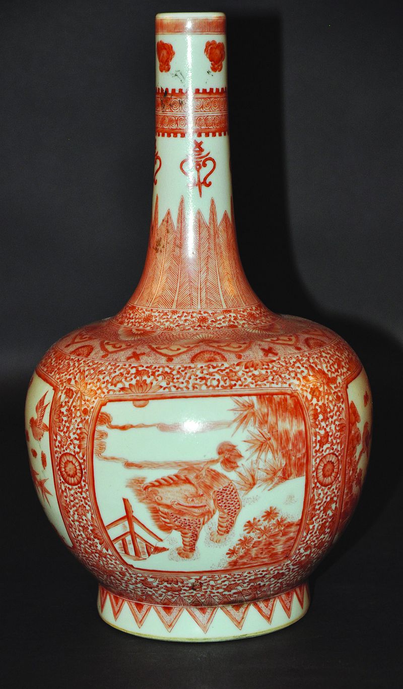 A CHINESE ROUGE-DE-FER PORCELAIN BOTTLE VASE, the sides well decorated with panels of kylin