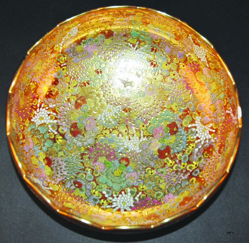 A 20TH CENTURY JAPANESE SATSUMA BOWL, densely painted with overlapping flower heads, 11.75in