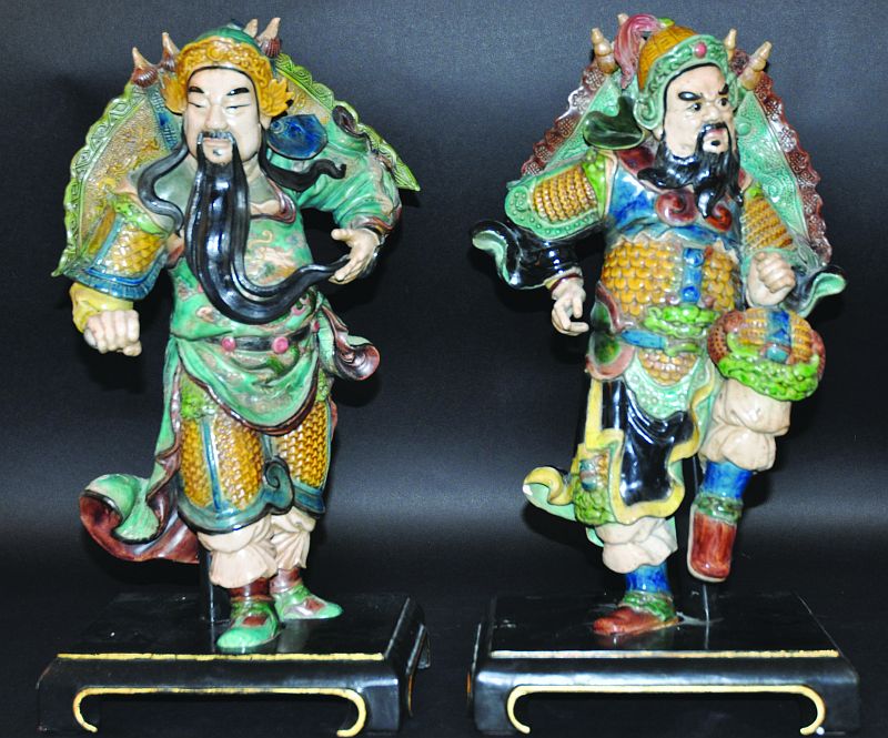 A PAIR OF 19TH/20TH CENTURY CHINESE GLAZED TEMPLE WARRIORS, each with elaborate robes, each standing