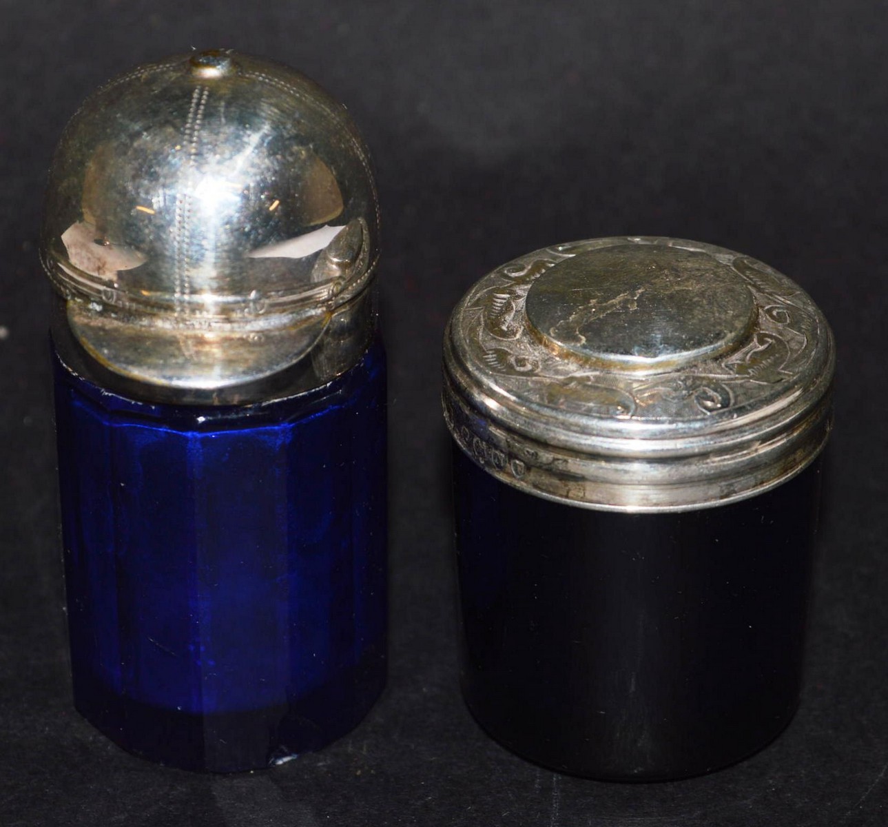 TWO BRISTOL BLUE GLASS SILVER TOP BOTTLES, one the top as a jockey cap.
