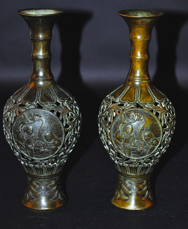 A PAIR OF 19TH/20TH CENTURY CHINESE PIERCED BRONZE VASES, decorated with circular panels of the He