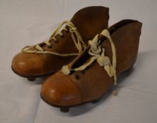 Old football boots marked 'The Alert'