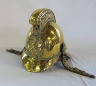 Brass Fireman's helmet with raised comb embossed with dragons & with leather backed chin strap.