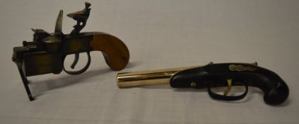 Dunhill tinder gun lighter & one other lighter in the shape of a gun.