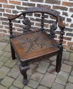 Carved dark oak corner chair with dolphin splats