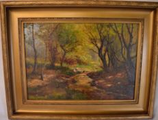 Oil on canvas of a figure by a woodland stream, signed Ernest Walbourn, 19.5" x 14"