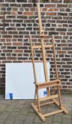 Lg easel & 2 lg blank artists canvas