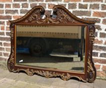 Ornate wall mirror with scroll pediment with gilded carving