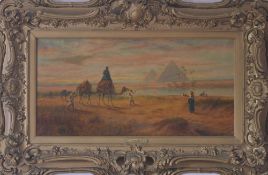 Oil on canvas of an Egyptian desert scene with nomads & water carriers in foreground & pyramid in