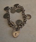 Silver curb chain bracelet with a silver padlock & 3 pence pieces, approx weight 1.4oz, London 1975
