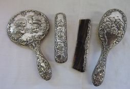 Silver dressing table set embossed with angel heads consisting of hand mirror, brush, comb & clothes