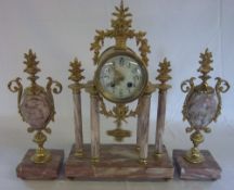 Three piece portico style pink marble clock garniture with enamel dial and painted floral swags with