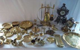 Assortment of brass items including trays, candlesticks, two clocks, decorative items etc