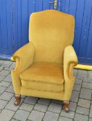 Velvet upholstered armchair with scrolled feet