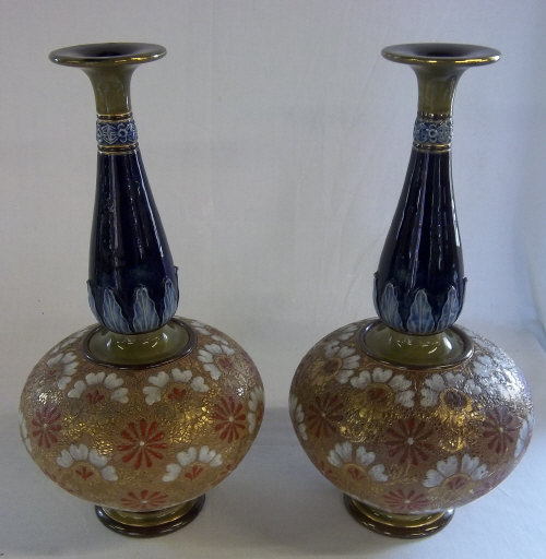Pr of Large Doulton Lambeth stoneware vases with a slender baluster form neck and a flared rim.