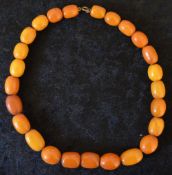 String of 25 amber beads, mottle opaque & slight irregular graduation, approx 51g largest 2cm & 43cm