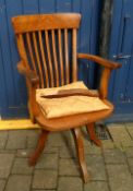 Early 20th cent office swivel chair with a broken leg