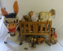 Wooden cot full of soft toys, dolls etc & a large donkey soft toy