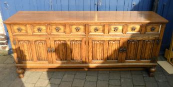 Oak Elizabethan style side board with linen fold panelling