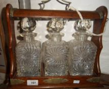 Edw three bottle tantalus with brass mounts, complete with key