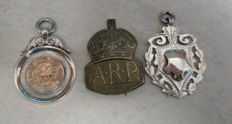 Silver Sainsburys cup medallion, silver medallion and an A.R.P badge