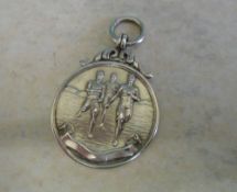 Silver medallion portraying 3 athletes running, engraved 'F.H' on the reverse, Birm 1947