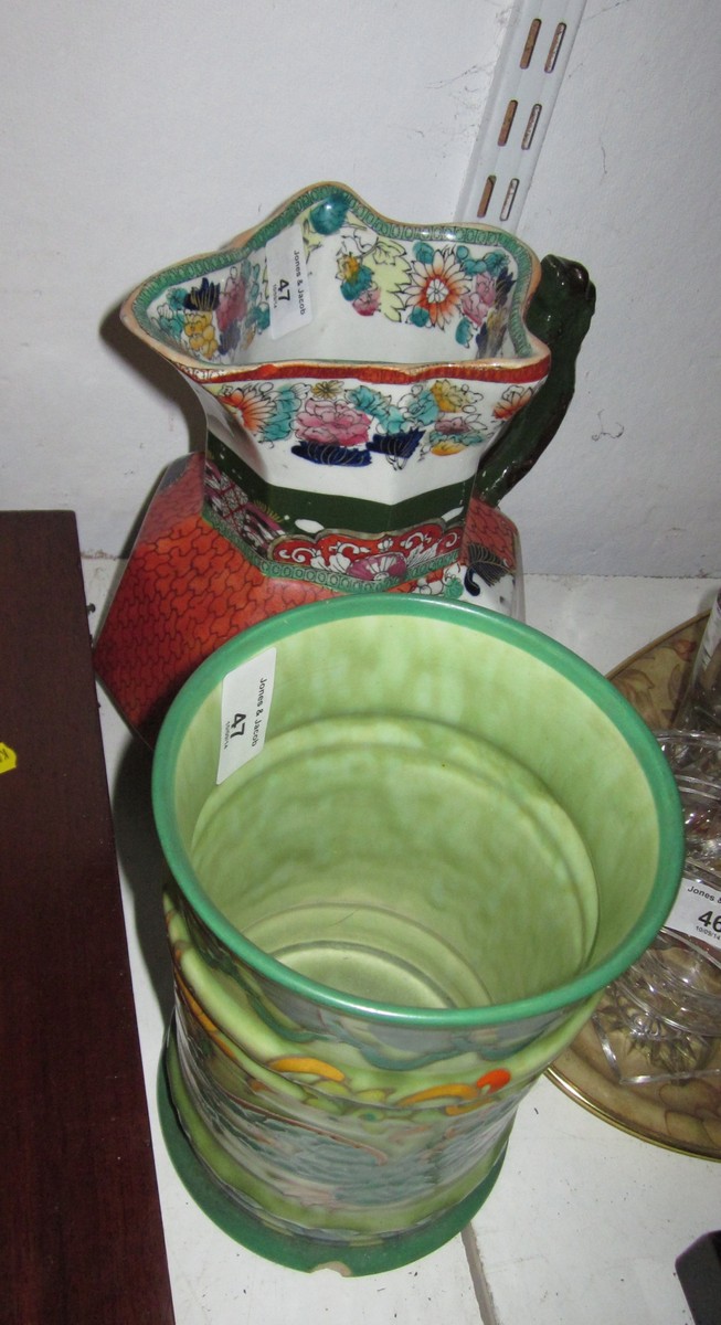 A Charlotte Rhead cylindrical tankard with double handle, sides painted green and gilt dragon, 8 1/