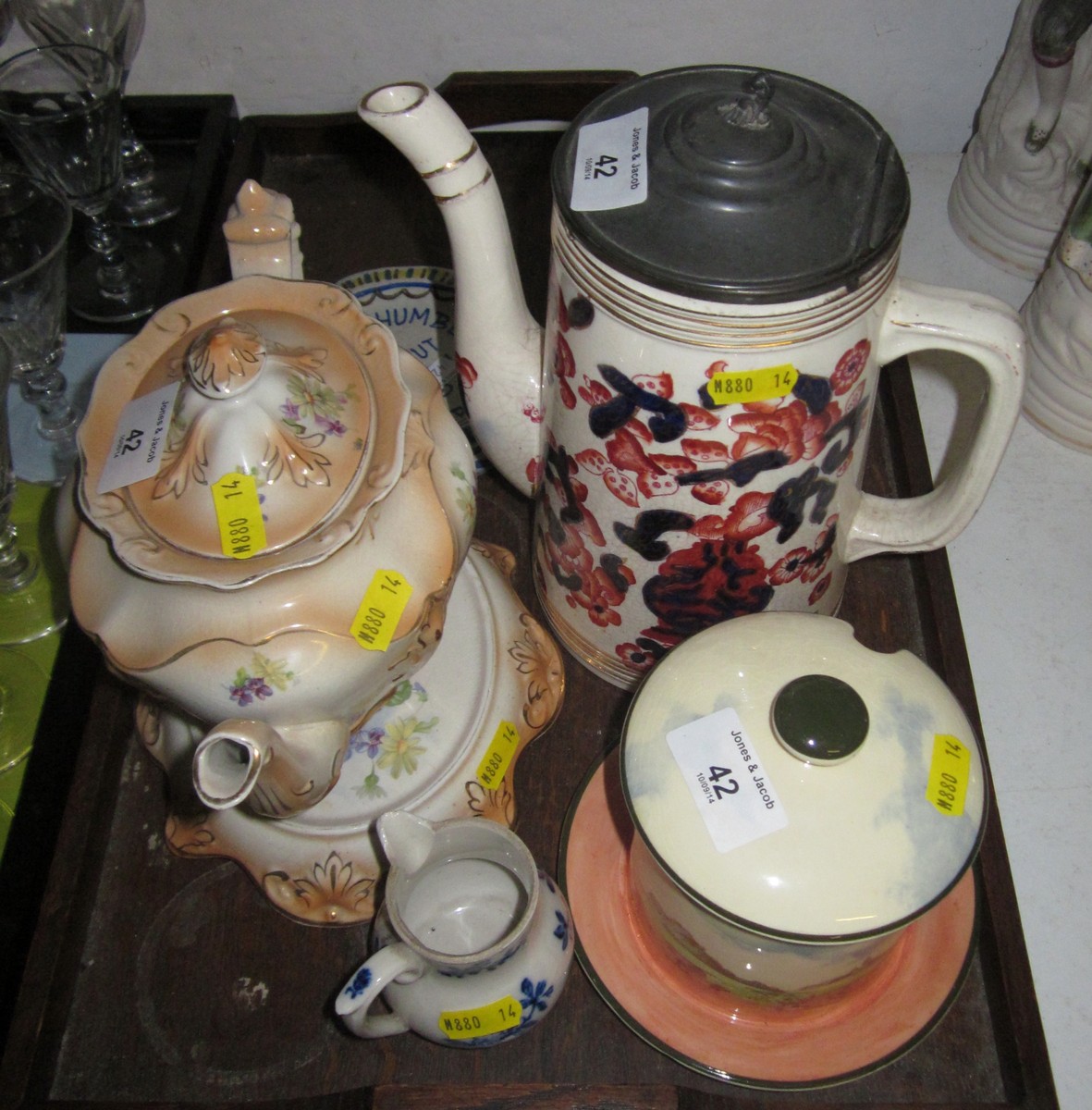 A figure decorated porcelain box and cover, a Doulton preserve jar and cover, a teapot, a coffee