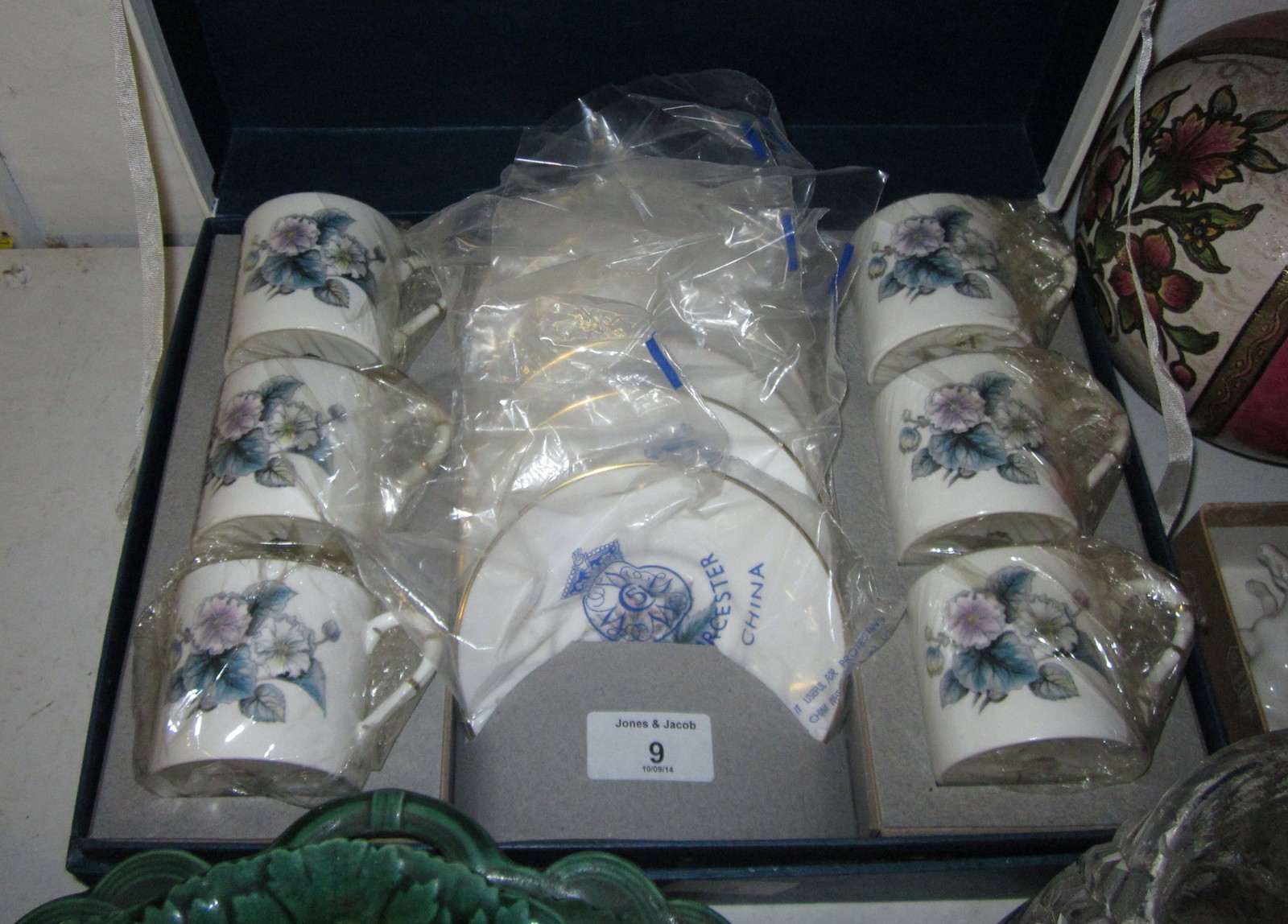 A set of six Royal Worcester bone china coffee cans and saucers with floral decoration, in original